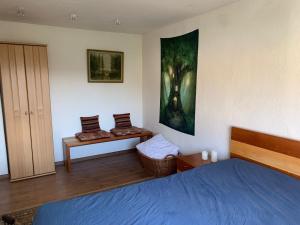 a bedroom with a blue bed and a painting on the wall at Business Apartment Herne-Wanne in Herne