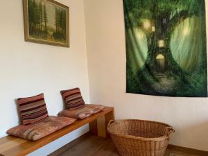 two benches sitting in a room with a painting at Business Apartment Herne-Wanne in Herne