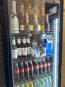 a refrigerator filled with lots of bottles of alcohol at Secret Labelle Époque Hideaway in Berlin