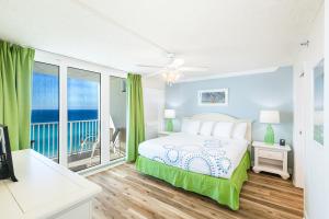 a bedroom with a bed and a balcony with the ocean at Landmark Holiday Beach in Panama City Beach +44 photos