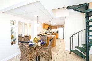 a kitchen and dining room with a table and chairs at Landmark Holiday Beach in Panama City Beach