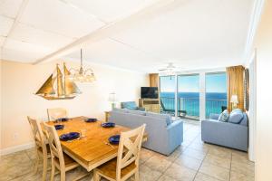 a dining room with a table and a couch at Landmark Holiday Beach in Panama City Beach