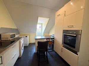 a small kitchen with a table and a counter top at Zimmer in Kaiserslautern in Kaiserslautern
