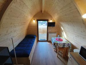 a small room with a couch and a table at Camping Deva in Deva