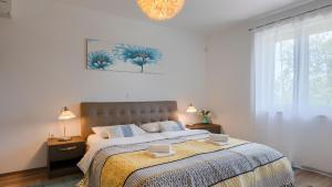 a bedroom with a large bed and a chandelier at Vila LeDa by Villas Guide in Barban +30 photos