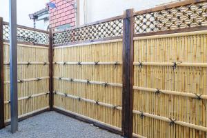 a wooden fence with a gate in front of a building at Tachikawa City 3LDK Private House in Tachikawa
