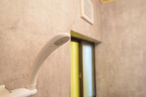 a white toothbrush hanging on a wall in a bathroom at Tachikawa City 3LDK Private House in Tachikawa +51 photos