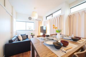 a living room with a wooden table with bowls on it at Tachikawa City 3LDK Private House in Tachikawa