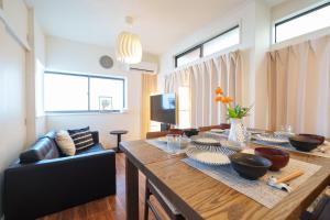 a living room with a table and a couch at Tachikawa City 3LDK Private House in Tachikawa