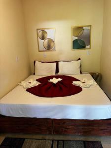 a bedroom with a large bed with a red blanket at Pousada Meraki Paraty Mirim in Paraty +71 photos