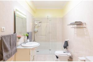 a bathroom with a sink and a shower and a toilet at Villa Lobos Flat 1 in Câmara de Lobos +37 photos