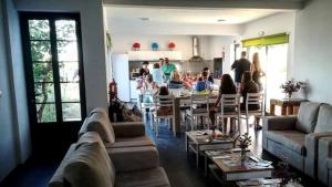 a living room with a group of people in a kitchen at BELO CAMPO - Ilha do Faial (Horta) in Castelo Branco