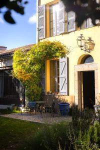 a yellow house with a table and chairs in front of it at Maison Sumiane - Maison d hotes et locations avec piscine in Brignoles +36 photos