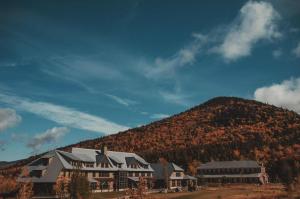a large building in front of a mountain at Highland Center in Bretton Woods