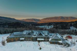 an aerial view of a lodge in the snow at Highland Center in Bretton Woods