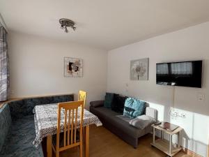 a living room with a couch and a table at Haus Viola in Samnaun
