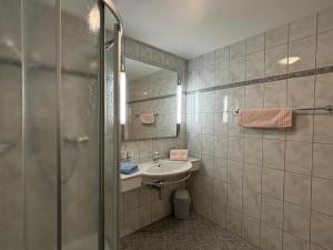 a bathroom with a sink and a mirror at Haus Viola in Samnaun +40 photos