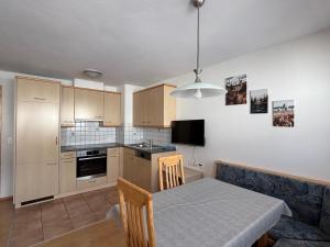 a kitchen with a table and a dining room at Haus Viola in Samnaun
