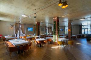 a restaurant with tables and chairs and christmas decorations at IREPALACE Goderdzi in Goderdzi