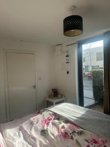 a bedroom with a bed and a door to a street at Cozy Room , prime location in Dublin