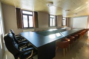 a large conference room with a long table and chairs at IREPALACE Goderdzi in Goderdzi