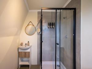 a bathroom with a shower and a sink at Five Elements Resort - Dome Glamping Tent in Harkerville +8 photos
