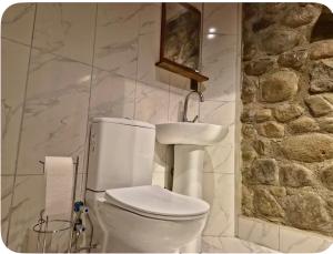 a bathroom with a white toilet and a sink at MiNKA HOUSE in Hisarcık +21 photos