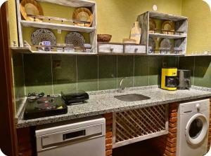 a kitchen with a sink and a washing machine at MiNKA HOUSE in Hisarcık