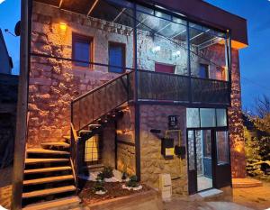a stone building with a staircase in front of it at MiNKA HOUSE in Hisarcık