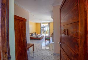 a hallway with a door and a living room at Double A Nungwi Beach Hotel - Beach Front in Nungwi
