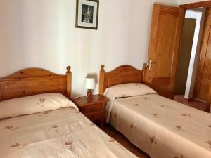 a bedroom with two beds and a table with a lamp at Jeribel PlayA1 in Fuengirola