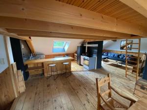 a large room with a kitchen and a living room at Loft des Cimes - Evasion en montagne avec local vélo privé in Cornimont