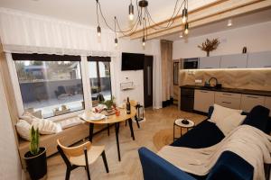 a living room with a couch and a table at Bukowe Wzgórza in Trzebniów