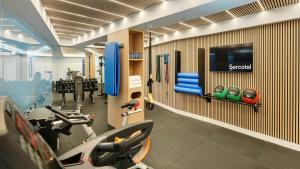 a gym with cardio equipment and a tv on a wall at Sercotel HMO Martina in Granada +54 photos