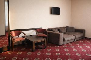 a living room with a couch and a table and chairs at Смерекова хата in Pavlohrad