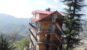 a building on the side of a mountain at Shimla View Home in Shimla