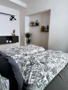 a bedroom with a bed with a comforter on it at Wohnzeit by Zirwick Apartment in Windischeschenbach