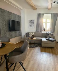 a living room with a couch and a table at Wohnzeit by Zirwick Apartment in Windischeschenbach