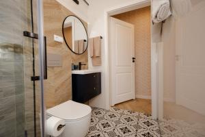 a bathroom with a toilet and a sink and a mirror at Bukowe Wzgórza in Trzebniów +55 photos
