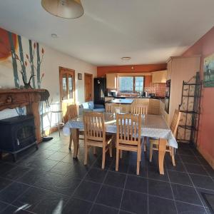a kitchen and dining room with a table and chairs at Wooly Lodge in Westport