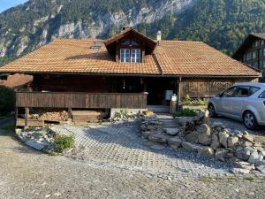 a house with a car parked in front of it at Lake view Chalet , Drligen in Därligen