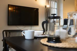 a table with two coffee cups and a tv at V&D 7 by Mountain ways in Rokytnice nad Jizerou