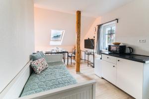 a living room with a couch and a kitchen at V&D 7 by Mountain ways in Rokytnice nad Jizerou
