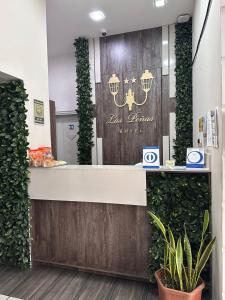 a cashier counter in a store with green plants at Hotel Las Peñas in Guayaquil