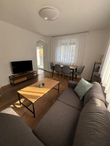 a living room with a couch and a table at Gemütliche Wohnung in Puch in Puch bei Hallein