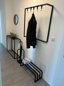 a mirror hanging on a wall next to a shelf at Gemütliche Wohnung in Puch in Puch bei Hallein +2 photos