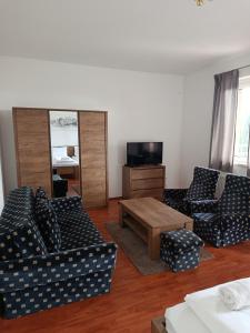 a living room with two couches and a coffee table at Panoráma apartman in Pécs