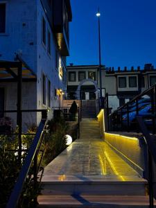 a staircase leading up to a building at night at Dione Bozcaada in Bozcaada