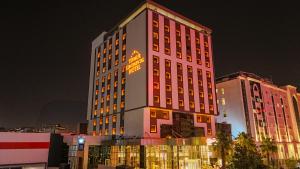 a tall building with a lit up sign on it at Teymur Continental Hotel in Gaziantep