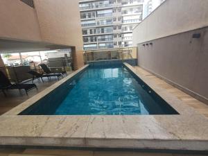 a swimming pool in the middle of a building at Talents in Vila Velha